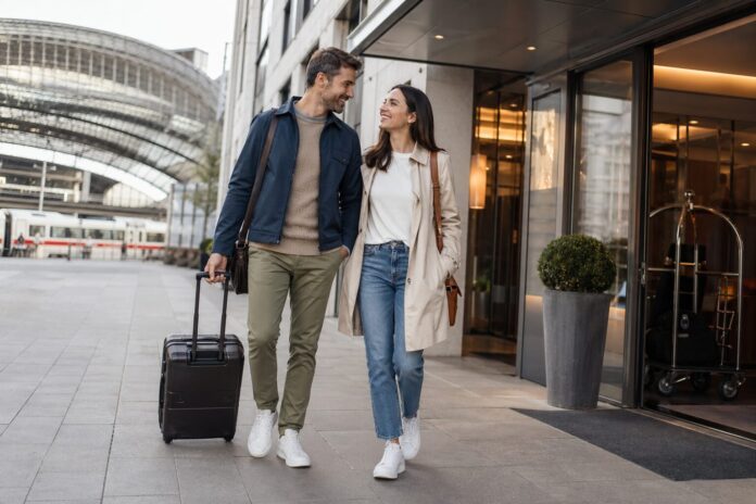 Reisende vor Hotel und Fernzug als Symbolbild für günstige Hotel-und-Bahn-Angebote